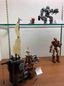 Display of the following LEGO sets: Angry Bird Ship, Iron Monger Mayhem, and Tony Stark's Sakaarian Iron Man