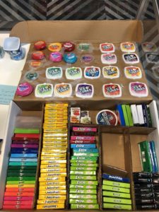 A box full of bubblegum containers of different shapes, sizes, and colors