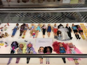 Display case with collection of dolls and miniature food