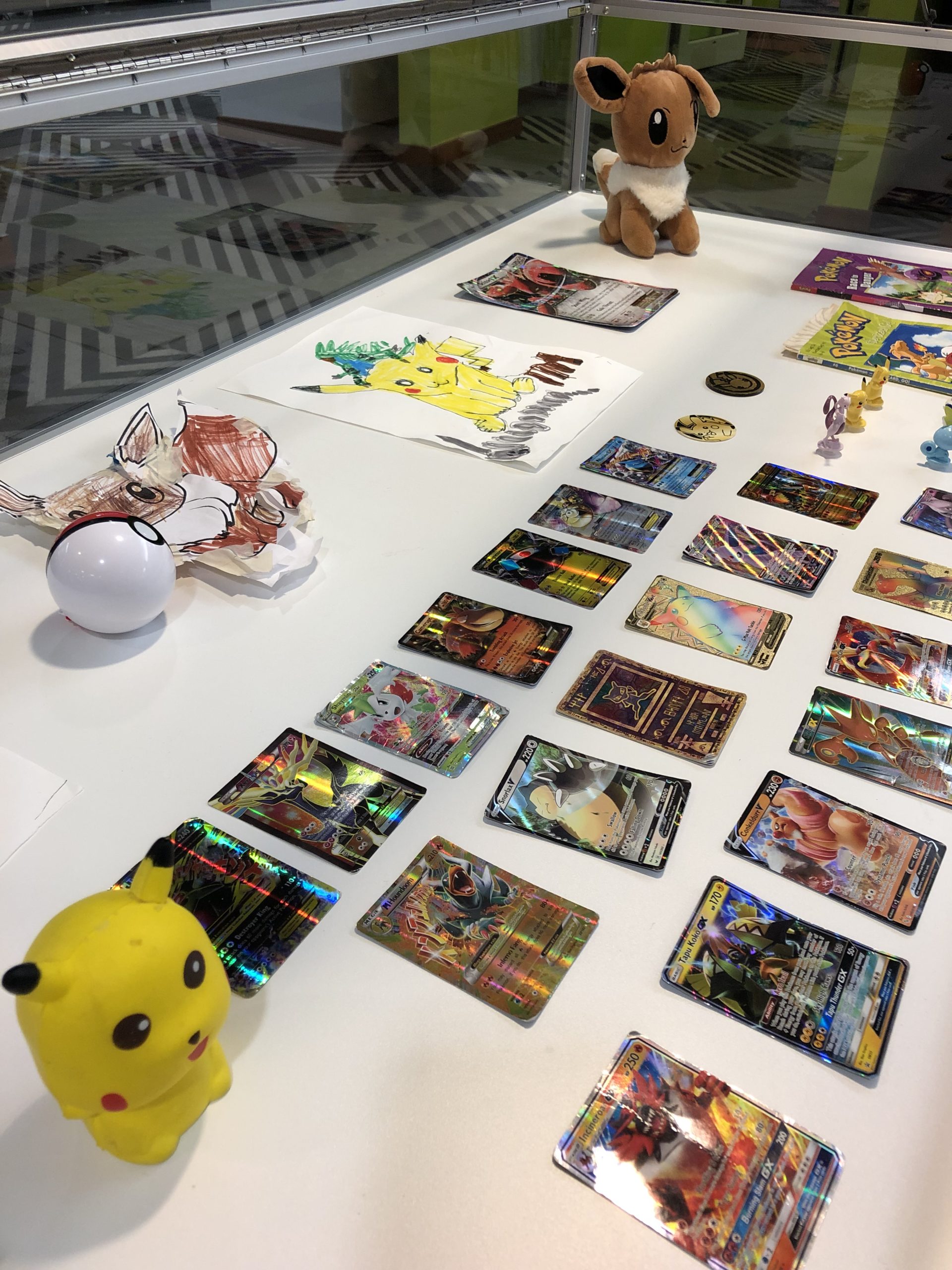 Display case of Pokémon cards and figurines