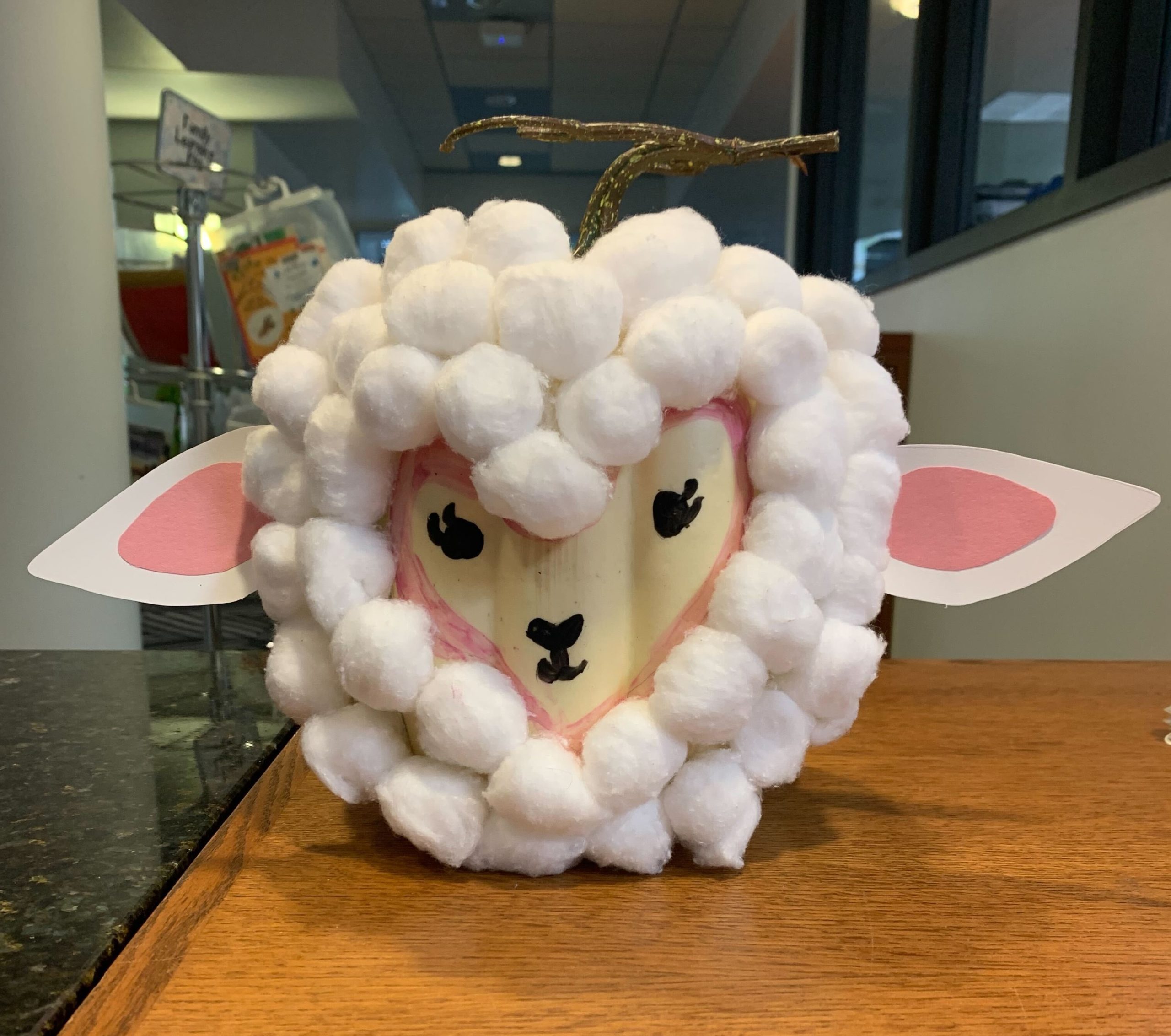 A pumpkin decorated with cotton balls and paper to look like Mary's Little Lamb