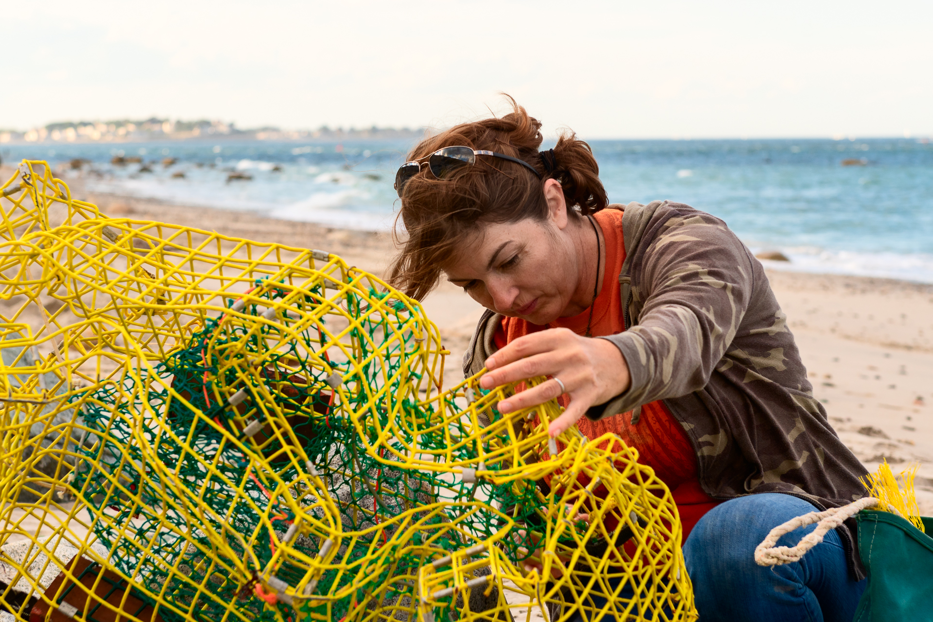 artist collecting beach debris for sculpture