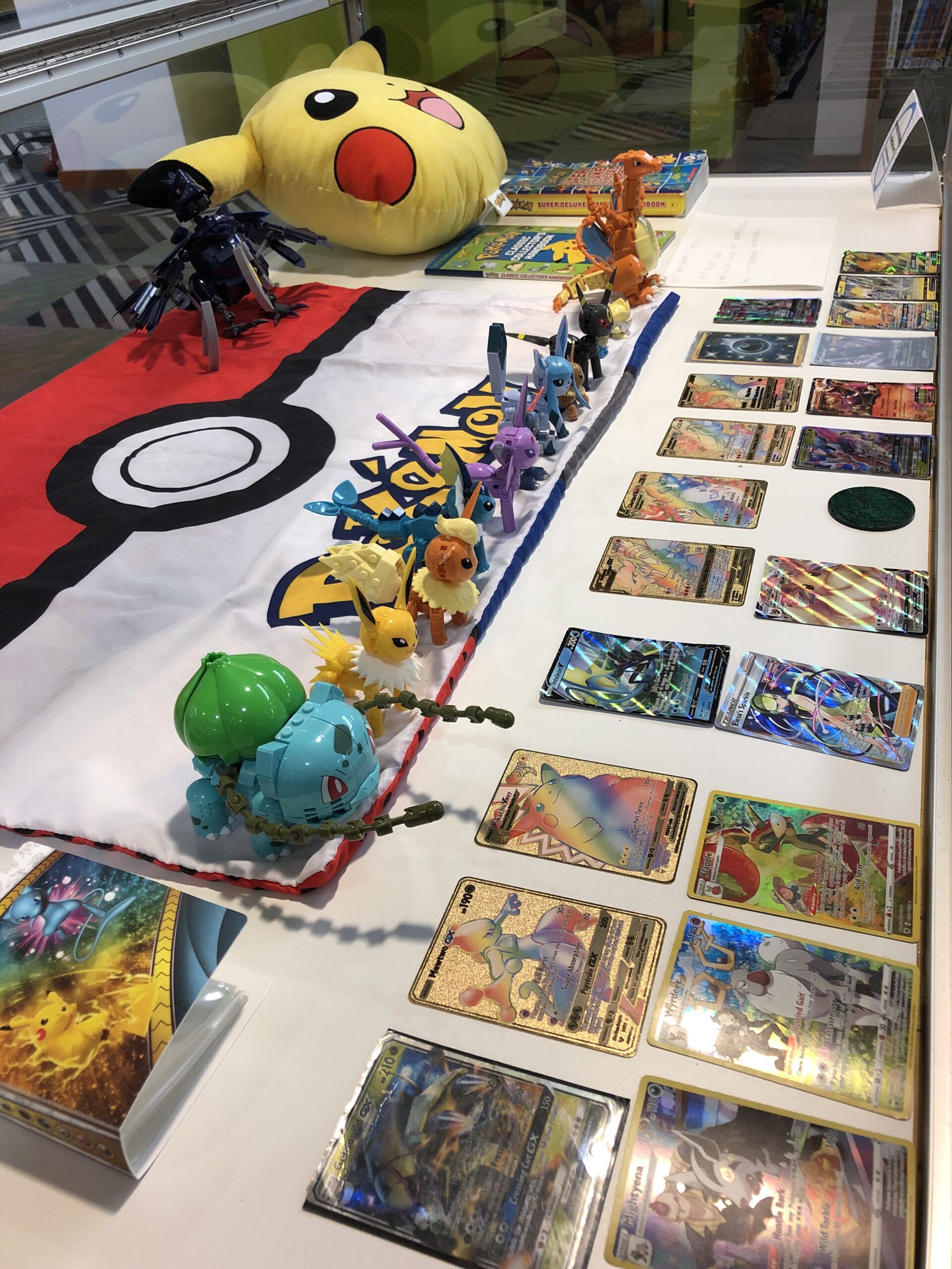 Display case of Pokémon cards and toys