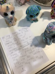 Hand-written note in display case, introducing Maya and her cat collection