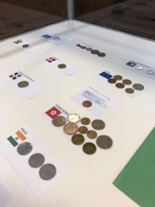 Collection of coins from around the world in a display case