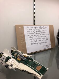 Star Wars LEGO set and hand-written artist statement in display case