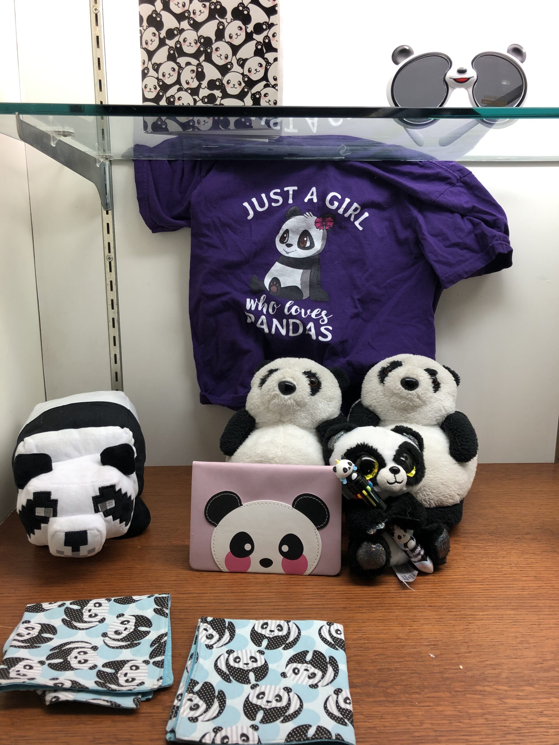 Collection of panda-themed items in a display case