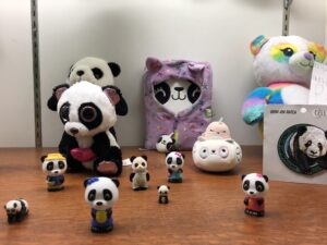Collection of panda toys in a display case
