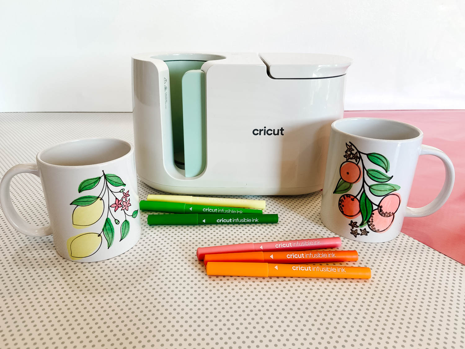 Cricut mug press, markers, and decorated mugs