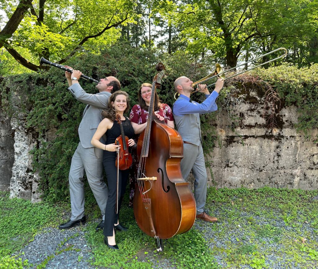 four klezmer band members with instruments