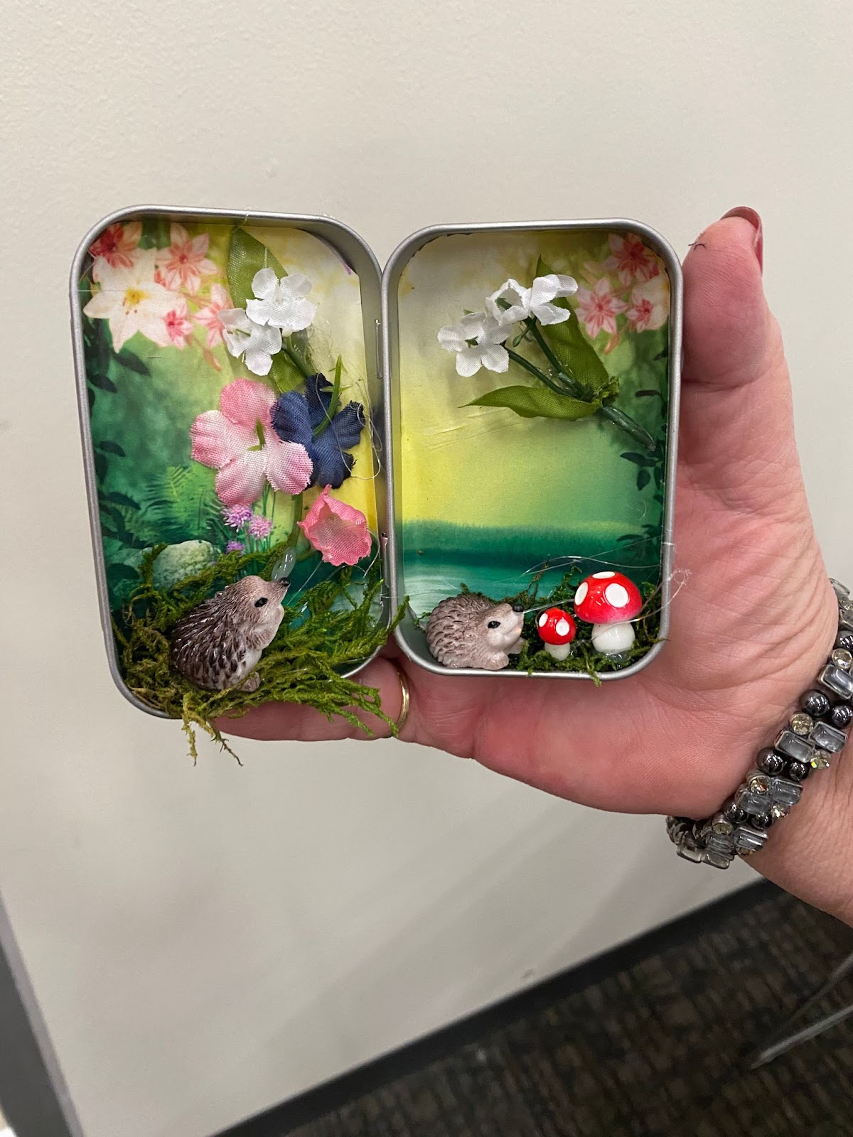 Miniature garden collage in a breath mints tin