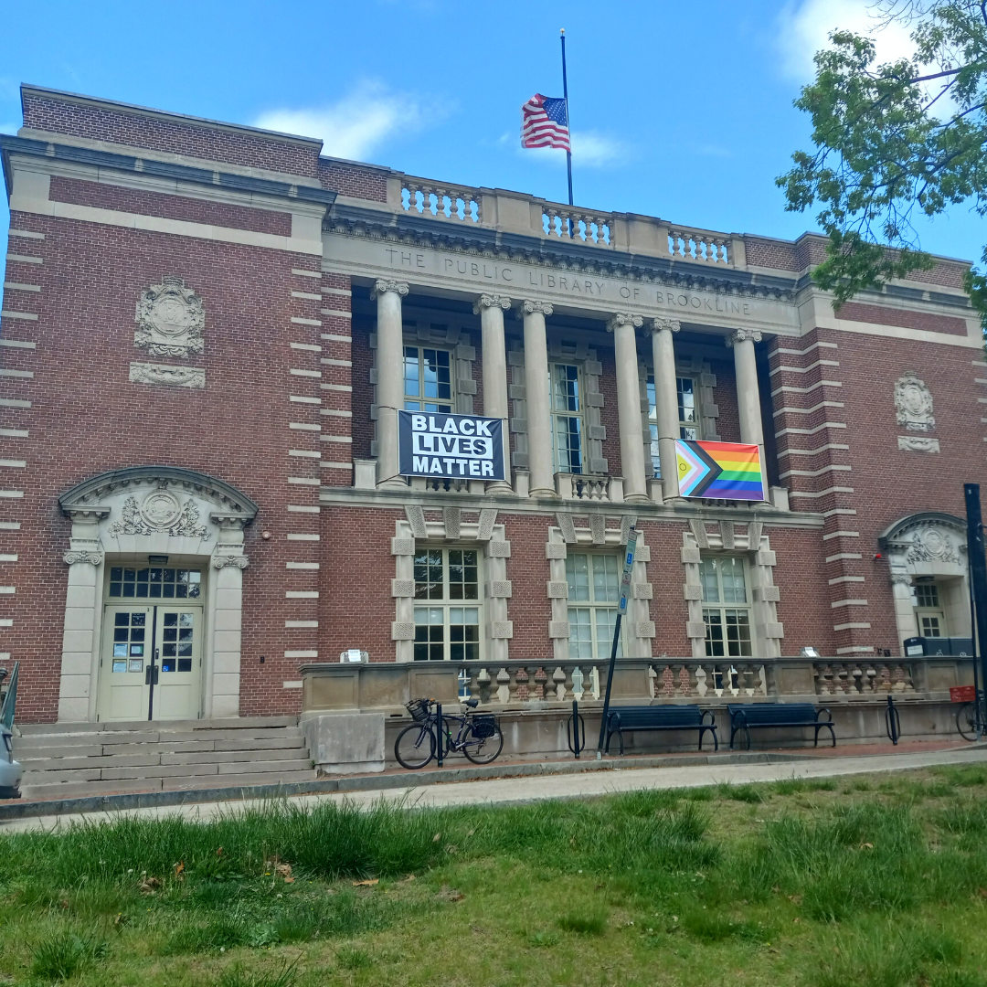 Photo of the Brookline Village Library with Black Lives Matter and Pride banners.