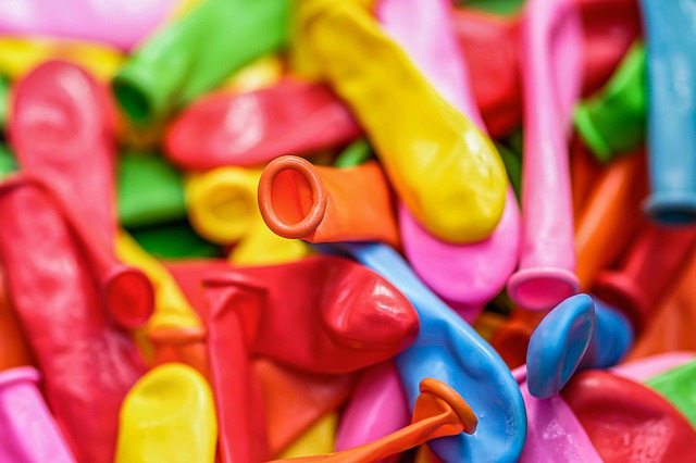 A pile of brightly colored uninflated balloons.